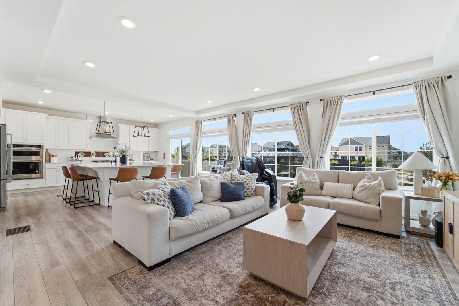 Bright Denver living room with large windows, real estate photography by Rewell Media